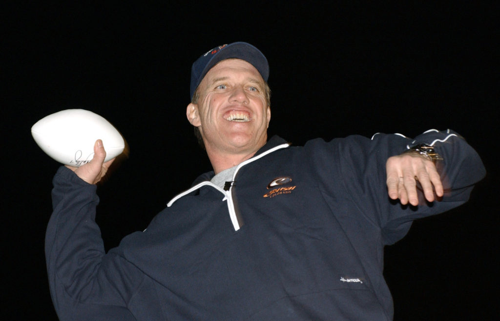 BALAD AIR BASE, Iraq (AFPN) -- John Elway tosses footballs to the crowd during the Chairman's United Service Organizations Holiday Tour here Dec. 14. (U.S. Air Force photo by Tech. Sgt. Marc Barnes)